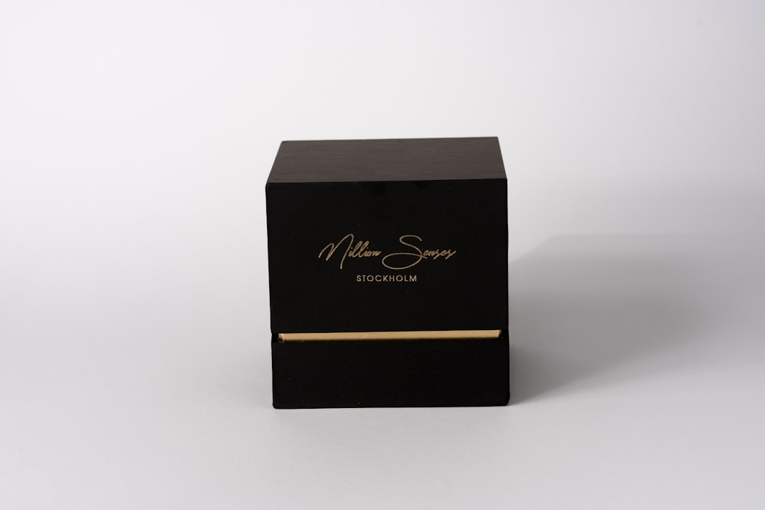 who-we-are a-black-box-with-gold-lettering-on-white-background-xm13ij445ag
